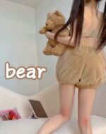 Model wearing kawaii bear pajamas, featuring a sweet lolita aesthetic. Close-up of brown plush pajamas.