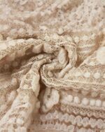 Close-up of a cream-colored coquette aesthetic top, featuring delicate lace and a patchwork design.