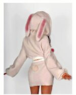 Close-up of bunny hooded plush pajamas in a soft pink color, featuring plush ears and a hood.