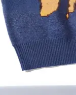 Close-up view of a blue cat reunion sweater with a retro design.