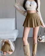 A brown preppy corduroy skirt with pleats, showcasing a classic and stylish design.