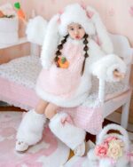Child wearing an Easter bunny costume featuring a fluffy pink coat and ears, with white boots and a carrot accessory.