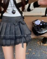 Black laced pleated korean aesthetic skirt with lace trim and tie closure.