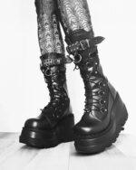 Black y2k punk boots with platform soles, laces, and buckles. Gothic style footwear.