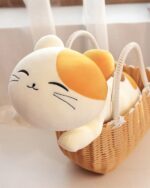 Kawaii cat plushie in a wicker basket, soft and cuddly.