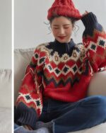 Close-up of a kawaii winter sweater featuring a colorful, geometric patterned knit design with fringe details.