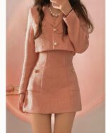 Pink retro aesthetic suit featuring a cropped blazer and pencil skirt.