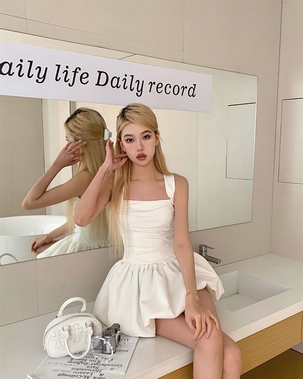 White coquette aesthetic dress with puff sleeves, worn by a person in a bathroom.