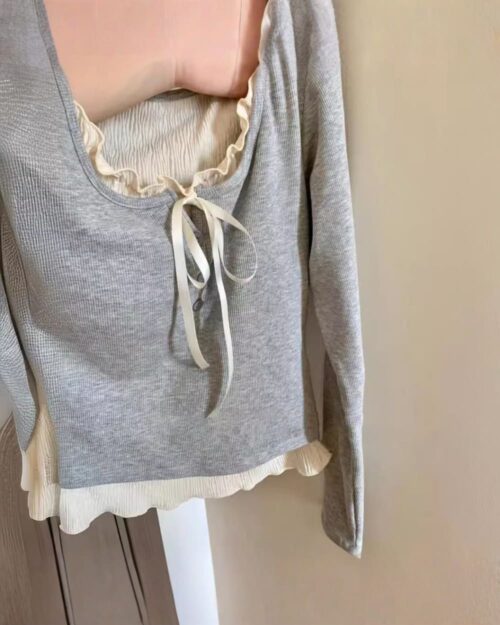 Gray vintage aesthetic sweatshirt with lace detailing and a bow tie closure.