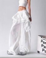 White y2k cargo pants with lace detailing and a ruffled hemline.