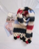 Fluffy rainbow scarf with red and blue stripes and pom-poms.