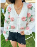 White vintage aesthetic cardigan with floral crochet embellishments and button closure.