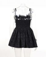 Black gothic aesthetic dress with lace details and a smocked bodice, shown on a mannequin.