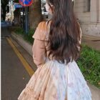 Soft girl dress in a floral print, light pink and white, with a layered skirt.