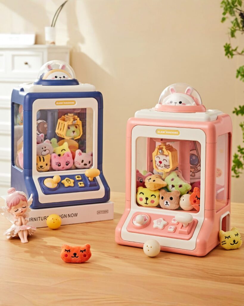 Two kawaii mini claw machines, one blue and one pink, each filled with plush toys.