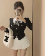 Black and white Korean aesthetic set with a blouse and pleated skirt, featuring a bow detail.