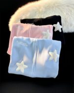 Stack of loose thick feathered harajuku hoodies with star embroidery.