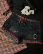 Dark blue kawaii denim shorts with red plaid lining and Y2K details.