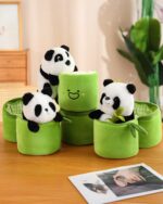 Several panda bamboo plushies nestled in green storage containers. Product: panda bamboo plushie.