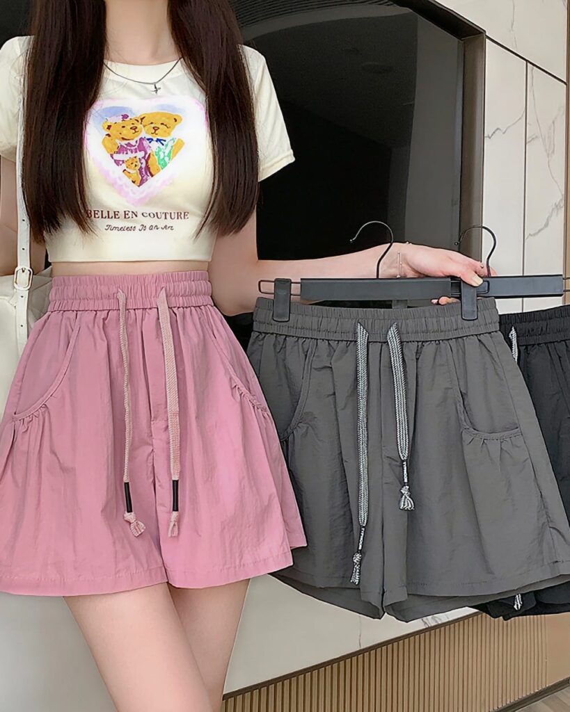 Pink and gray Korean aesthetic shorts displayed on a rack. Casual, elastic waist design.