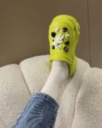 Close-up of cute waterproof platform sandals with M&M embellishments. Outdoor shoes.