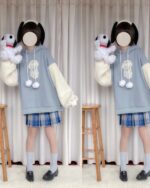 Model wearing a kawaii lamb hoodie with fluffy sleeves and a blue plaid skirt.