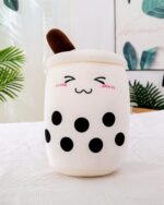 Cute boba milk tea plush toy with black tapioca pearls and a smiling face.
