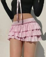 Bowed pink ruffled coquette aesthetic skirt with multiple layers and a high-waisted design.