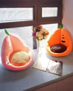 Two kawaii fruit cushions - an orange and a carrot design - displayed on a table.