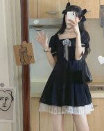 Black puffy dress with lace trim, part of a dark kawaii aesthetic outfit.