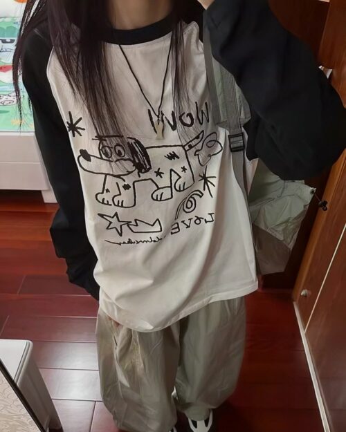 White dog doodle t-shirt with black sleeves and graphic design.