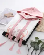 Pink sakura bunny hoodie featuring a black and white graphic design with tassels.