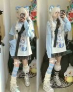 Harajuku detachable sleeve shirt outfit featuring a blue graphic tee and layered jacket with a plaid skirt.