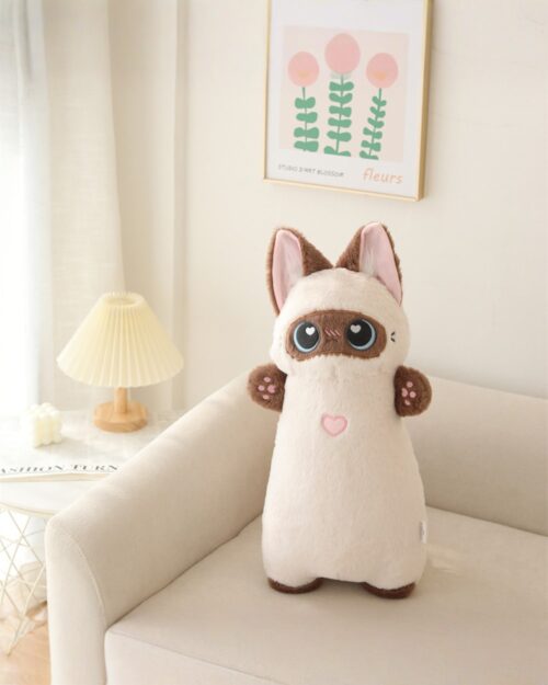 Kawaii Huggy Neko Cat Plushie sitting on a chair in a room.
