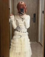 Thin Long Sleeve Top featuring a detailed print, layered with a frilly skirt and belt.