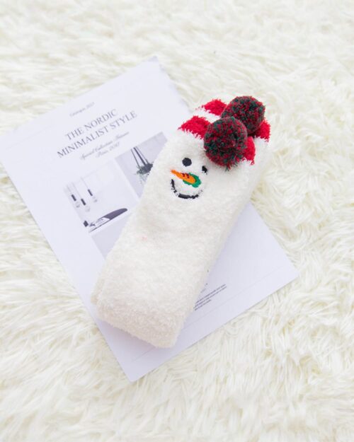 Close-up of a kawaii fluffy sock shaped like a snowman with pom-poms, product-keyword: kawaii fluffy socks