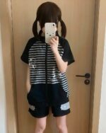 Black and white japanese striped loungewear set with cat graphic, worn by a person.