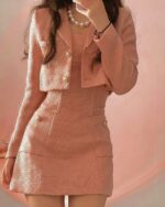 Pink retro aesthetic suit featuring a blazer and skirt with gold buttons.