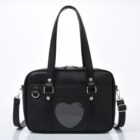 Black japanese schoolbag with heart window and handles.