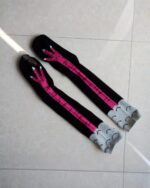 Pair of black chicken legs socks with pink design and gray cuffs.
