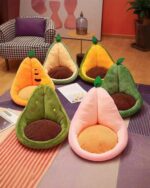 Several kawaii fruit cushions in orange, yellow, and pink, shaped like fruits with plush details.
