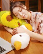 Close-up of a yellow banana duck plushie resting on a wooden table.
