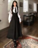 Elegant Uniform Set - Preppy Aesthetic featuring a black skirt and white shirt with tie and corset detail.