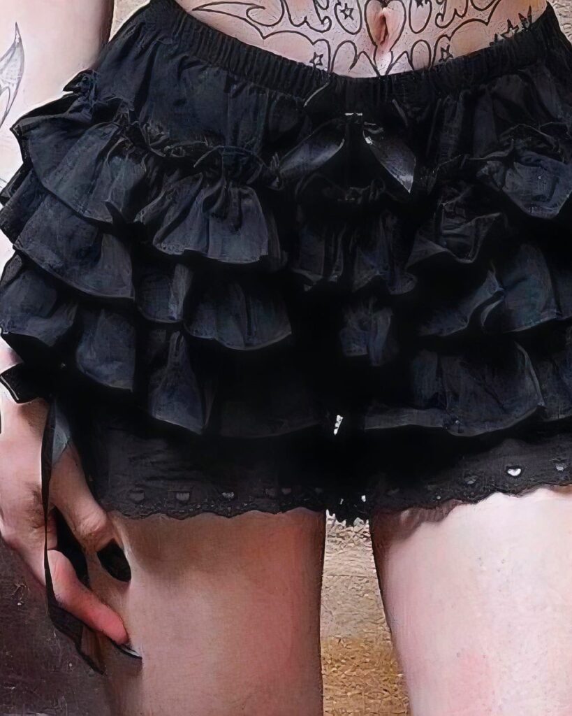 Black puffy gothic coquette skirt with lace trim, layered ruffles.