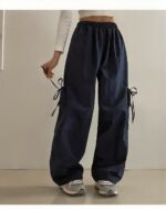 Dark blue loose laced **korean aesthetic pants** with tie closures, wide-leg style.