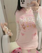 Pink pastel hooded dress featuring a cute cartoon print and hood.