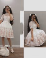 Two photos showing a white gothic lolita dress with lace sleeves and a floral pattern. It's a Suspender Dress.