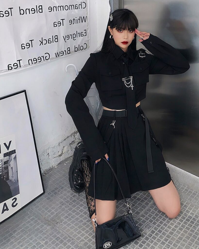 Black gothic aesthetic set featuring a pleated blazer and skirt, with accessories.