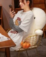 Kawaii duck plushie, Winston the Duck, displayed on a gold chair in a room setting.