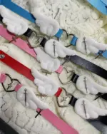 Collection of Winged Heart Necklaces in various colors and with cross embellishments. Harajuku aesthetic jewelry.